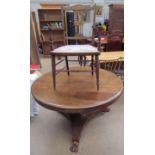 A Victorian mahogany supper table with a circular top and octagonal column and trefoil base and