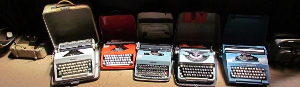 A Brownie Eight-58 projector together with an Olympia typewriter, Hermes Baby typewriter, Olivetti