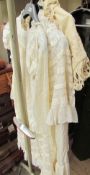 A collection of Edwardian lace christening gowns and a jacket