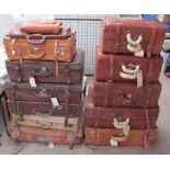 A collection of leather suitcases of varying designs and sizes