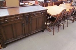 A 20th century oak dresser base with two drawers and two cupboards on stiles together with a draw