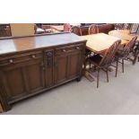 A 20th century oak dresser base with two drawers and two cupboards on stiles together with a draw