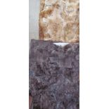Two fur rugs together with other rugs and mailing sacks