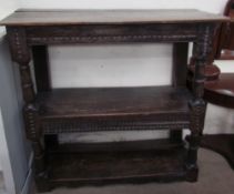 An 18th century and later oak buffet, the planked top above two shelves separated by ring turned