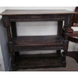 An 18th century and later oak buffet, the planked top above two shelves separated by ring turned