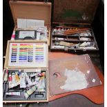Artists pallets together with paints, brushes etc