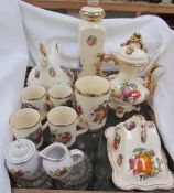 Kilncraft pottery mugs decorated with fruit together with other pottery items including a teapot,