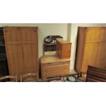 A 20th century oak bedroom suite comprising two wardrobes, dressing table and bedside cabinet