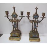 A pair of gilt and enamel decorated candelabra, with twin branches on stepped square base