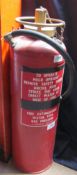 An red painted and brass fire extinguisher containing 2 imperial gallons