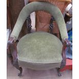 A Victorian rosewood library chair with a bowed upholstered back and arms, with an upholstered