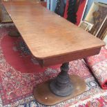 A ships table, with a large rectangular top with rounded corners on cast iron pedestal legs,