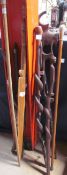 An African carved hardwood walking stick together with a snake carved walking stick, spears, folding