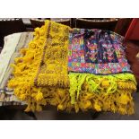 A large collection of Mexican fabrics including blankets, table coverings, cushion covers etc