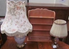 A hanging shelves with three shelves and a base drawer together with two table lamps