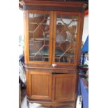A George III oak and mahogany standing corner cupboard with a moulded cornice above a pair of