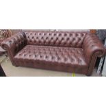A brown leather three seater chesterfield settee