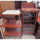 An Edwardian mahogany cabinet with a carved cornice above a glazed door with glazing bars,