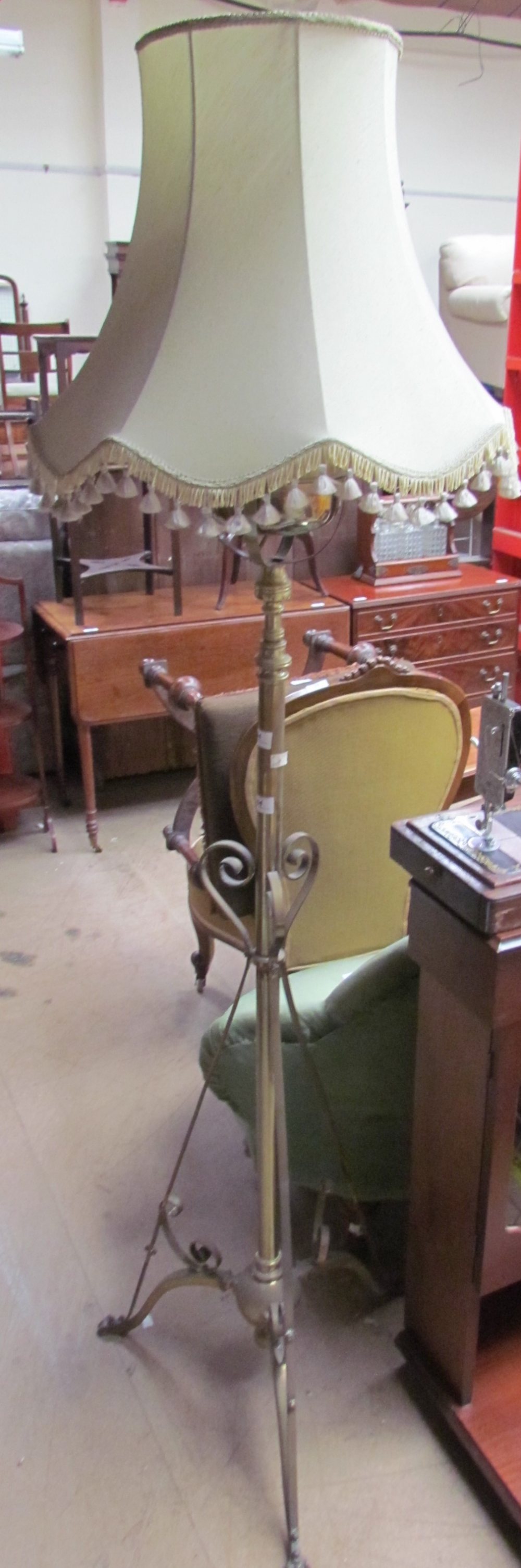 A brass standard lamp, now converted to electricity,