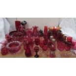 A large quantity of cranberry glass including vases, jugs, wine glasses,