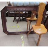 An oak framed wall mirror together with an elm seated three legged back stool