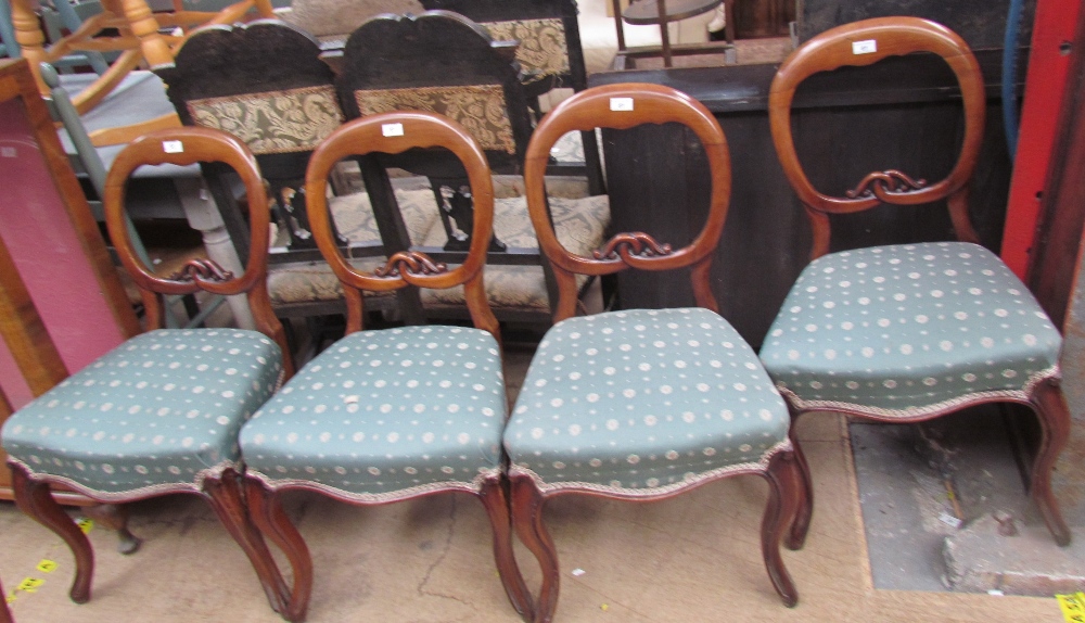 A set of six Victorian mahogany balloon back dining chairs with upholstered seats on shaped legs