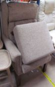 A modern upholstered wing back chair and matching foot stool