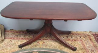 A Regency mahogany table section of "D" outline on a ring turned column and four reeded legs with