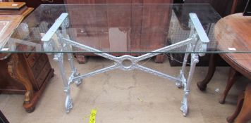 A cast iron table base with a silver painted cast iron base
