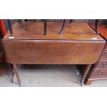 A Victorian mahogany Pembroke table with drop flaps and a drawer on ring turned legs and casters