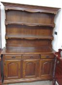 A modern dresser, with a moulded cornice above two shelves,