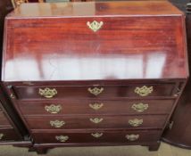 A George III mahogany bureau, the sloping fall enclosing a fitted interior,