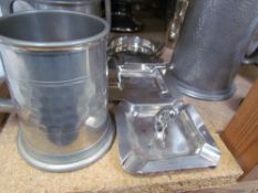 A silver ashtray of square form decorated with a golfer together with assorted electroplated trophy