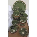 A modern Nantgarw pottery part tea set decorated in green with cream circular decoration,