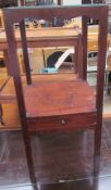 A George III mahogany washstand of square form, with a recessed top above an undertier,