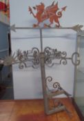 A wall mounted weather vane with a Welsh Dragon surmount
