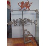 A wall mounted weather vane with a Welsh Dragon surmount