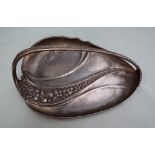 An electroplated WMF dish, of leaf shape with a fixed handle, cast with leaves and fruit, 27cm long.