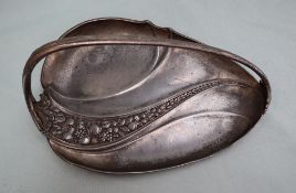 An electroplated WMF dish, of leaf shape with a fixed handle, cast with leaves and fruit, 27cm long.