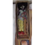 A Pelham puppet of a black marionette together with an Armand Marseille bisque head dolls and a