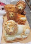 Three various Staffordshire pottery lions