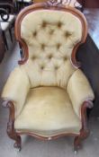 A Victorian mahogany framed spoon back library chair with button back upholstery,