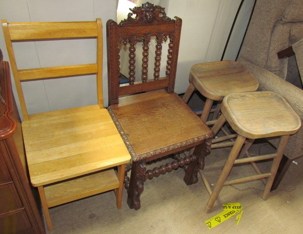 A modern oak metamorphic library chair together with a carved oak chair and a pair of stools