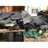 A large collection of leather clothes including jackets, skirts,