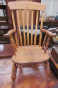 A slat back kitchen chair with a solid seat on ring turned legs