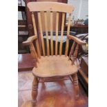 A slat back kitchen chair with a solid seat on ring turned legs