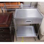 A stainless steel kitchen side table with a drawer and shelf together with a stainless steel