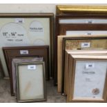 A collection of photograph and picture frames and modern oil paintings