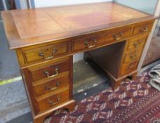 A Victorian pedestal desk with a leather inset top above a central drawer and two pedestals of