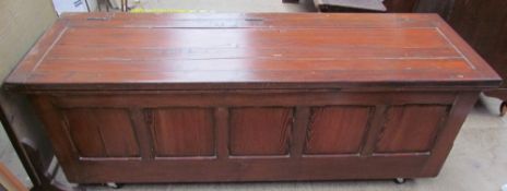 A 20th century pine trunk with a planked top on casters